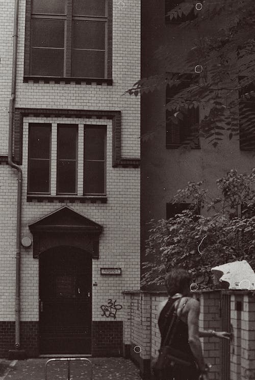 Person in front of an Apartment House