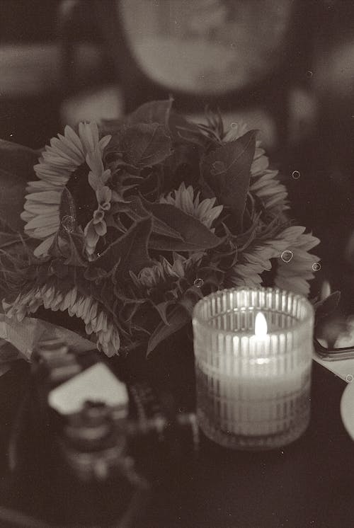 A Still Life of a Candle and a Flower 