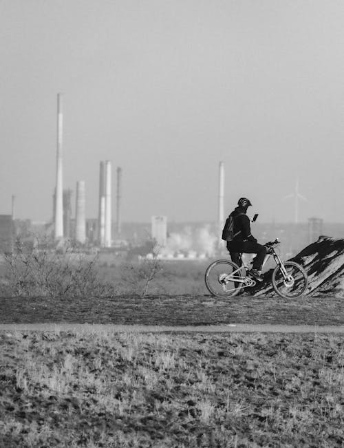Black and White Candid Shot of a Person on a Bicycle 