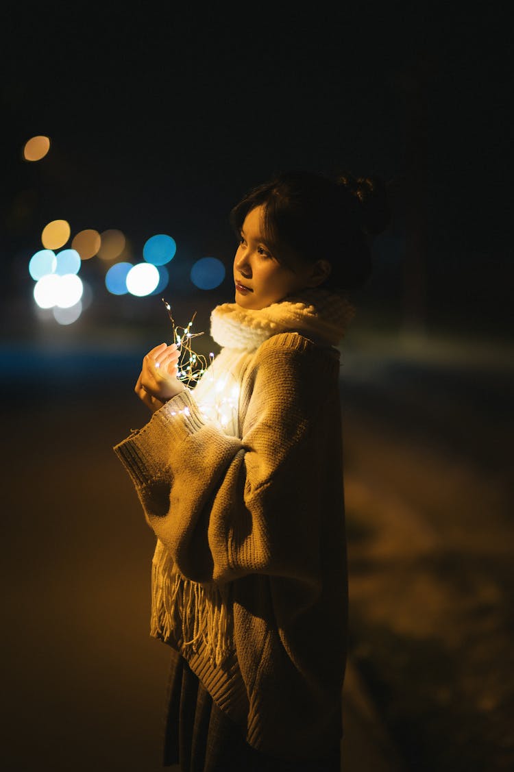 Woman Holding Lights At Night