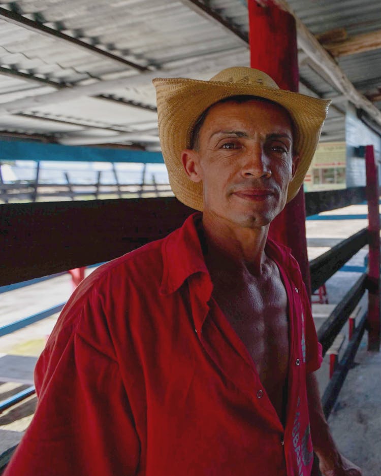 Portrait Of Man Wearing Straw Hat On A Railway Station 