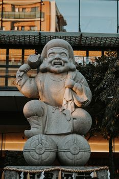 Beautiful Daikokuten statue at Kanda Myojin Shrine, Tokyo. Captured in warm lighting.
