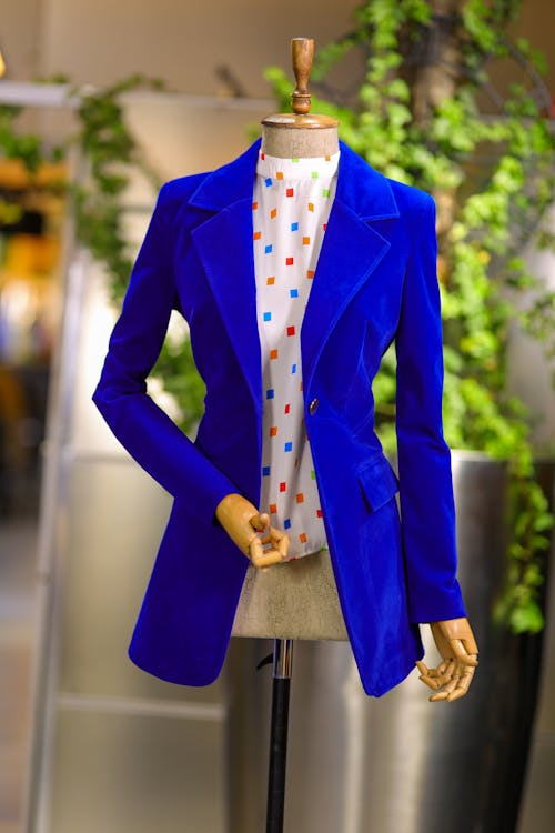 A Patterned Blouse and Blue Jacket on a Mannequin 