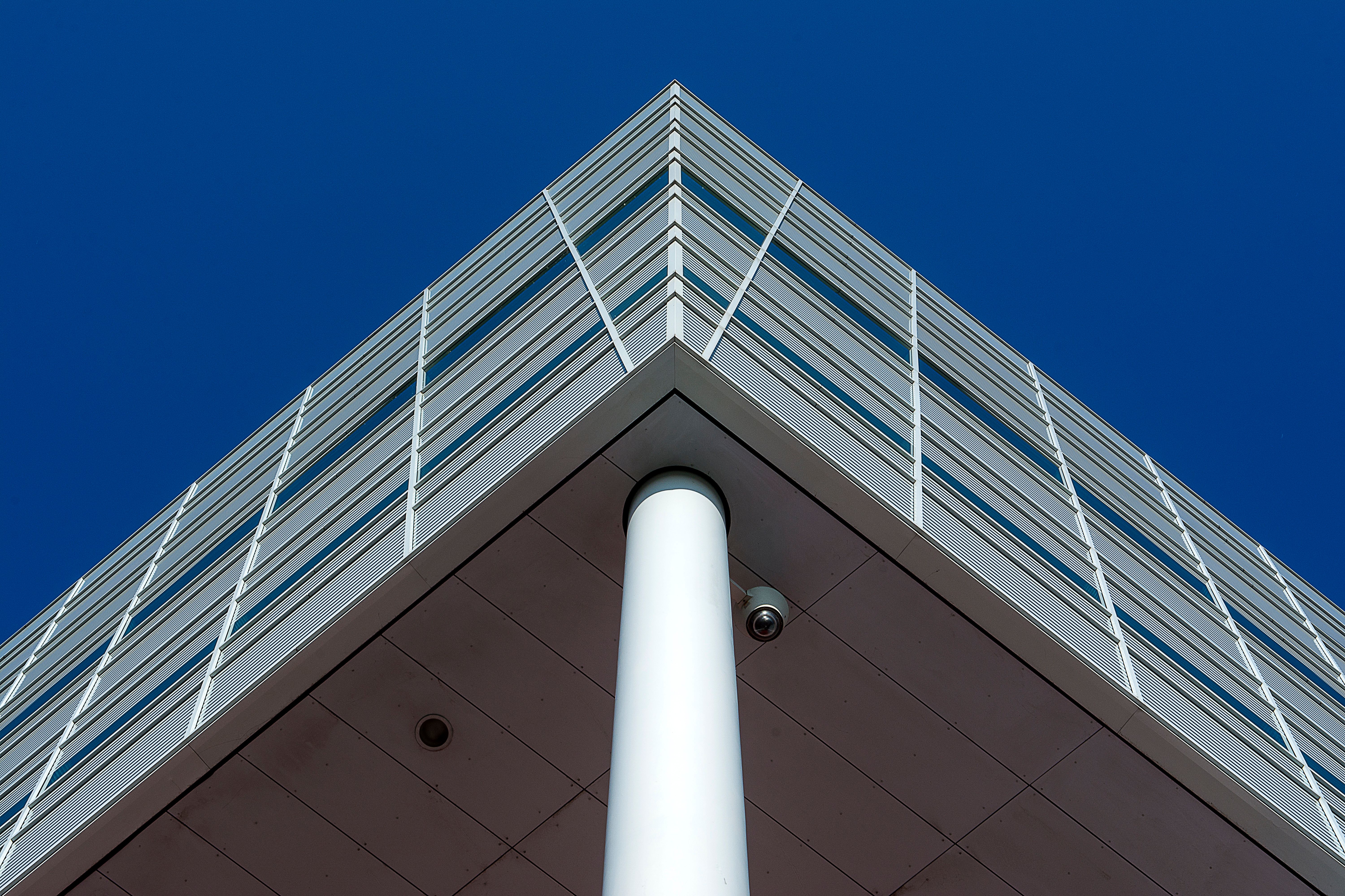 Low Angle Shot of a Modern Building under Blue Sky · Free Stock Photo
