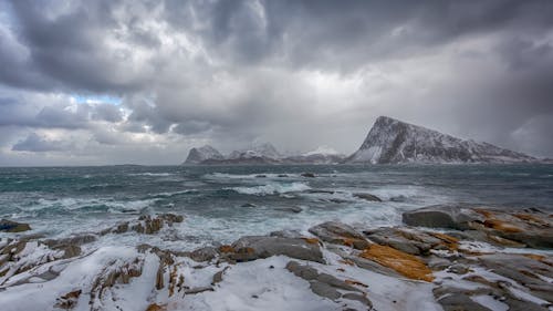 View of a Frosty Shore and Mountains at Lofoten Islands in Norway 