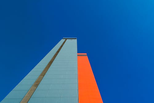 Low Angle Shot of a Modern Skyscraper under Clear, Blue Sky 