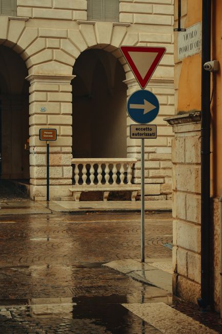 Elegant street view of Verona showing classic architecture and wet pavement after rain.
