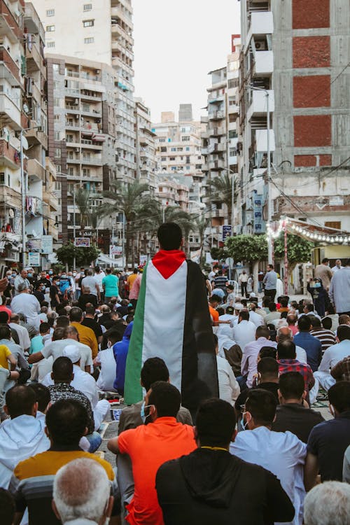 Crowd Protesting with Flag of Palestine on Street