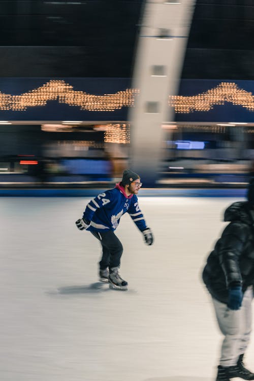 Man Skating on Ice Rink at Night
