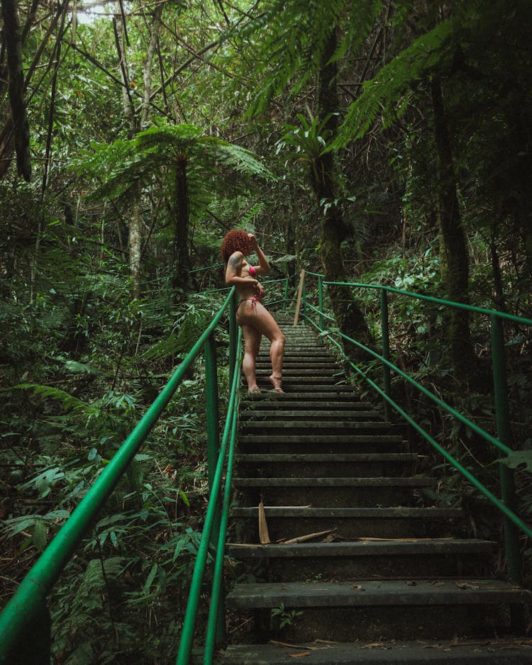 Woman In Bikini On Steps In Forest