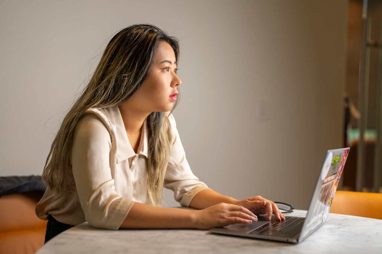 Data scientist working with a laptop in a real professional office environment