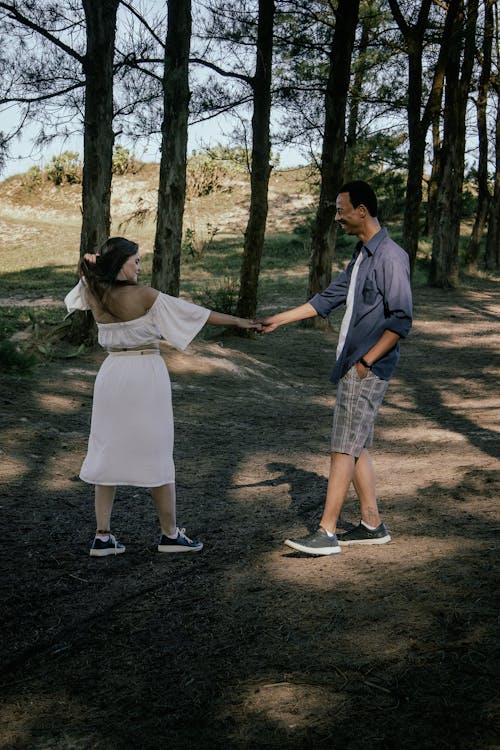 Couple Standing Together and Holding Hands near Forest