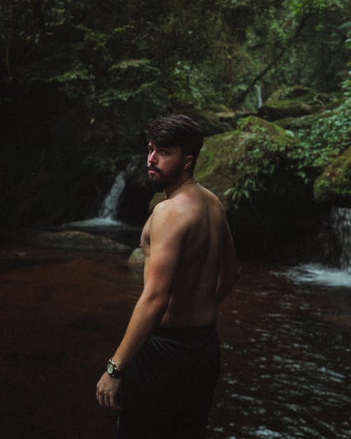 Man Standing by Lake in Forest