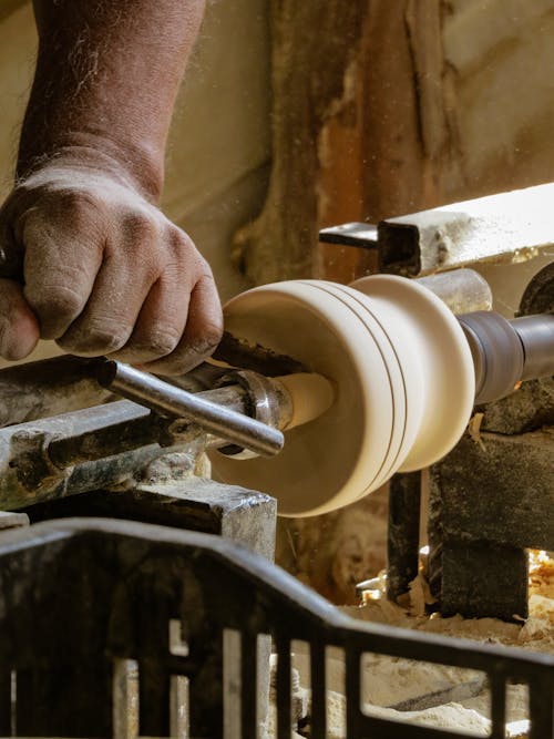 Hand of Artisan Working on Grinder