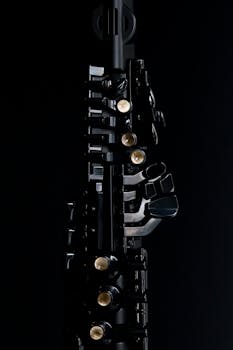 Close-up image of clarinet keys on a dark background, emphasizing detail and texture.