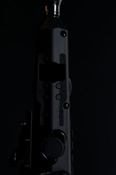 Artistic close-up of a metal device with knobs, emphasizing shadows and textures.