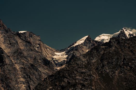 Majestic snow-covered peaks of the Himalayas under a dramatic sky in Kaza, India.