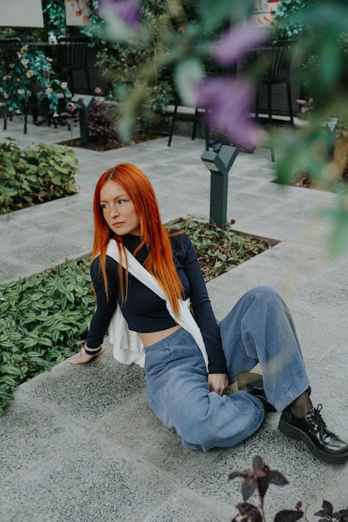 Redhead Woman Sitting on Pavement