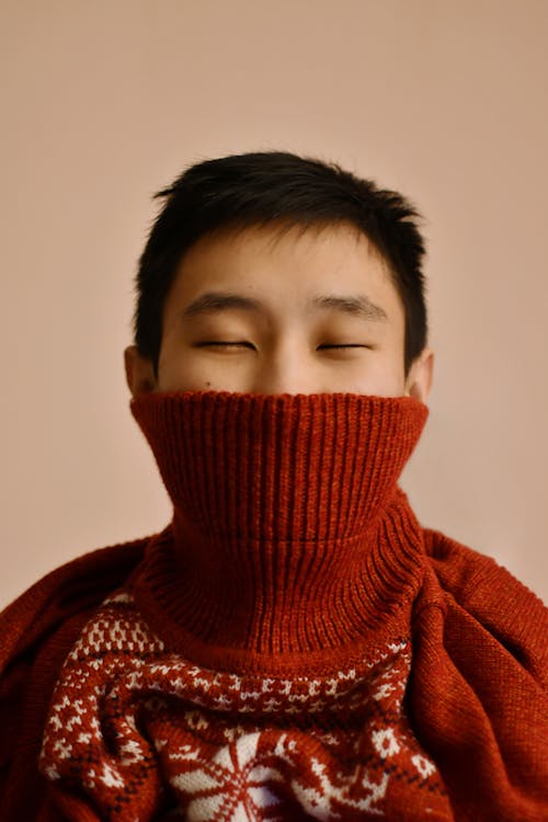 Man in a Red Sweater with His Eyes Closed