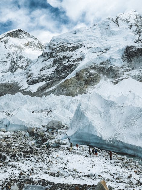 People Standing by a Huge Glacier on a Mount Everest · Free Stock Photo