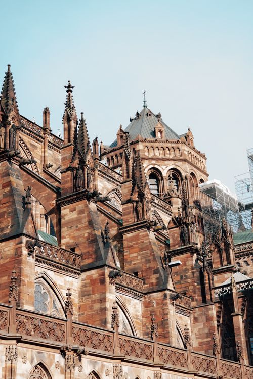 Free Close-up of a Gothic cathedral showcasing intricate architectural details in sunlight. Stock Photo