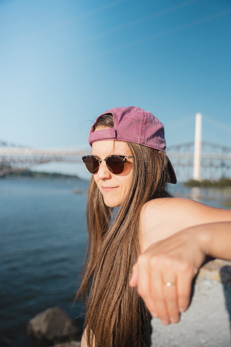 Portrait Of Woman In Cap And Sunglasses