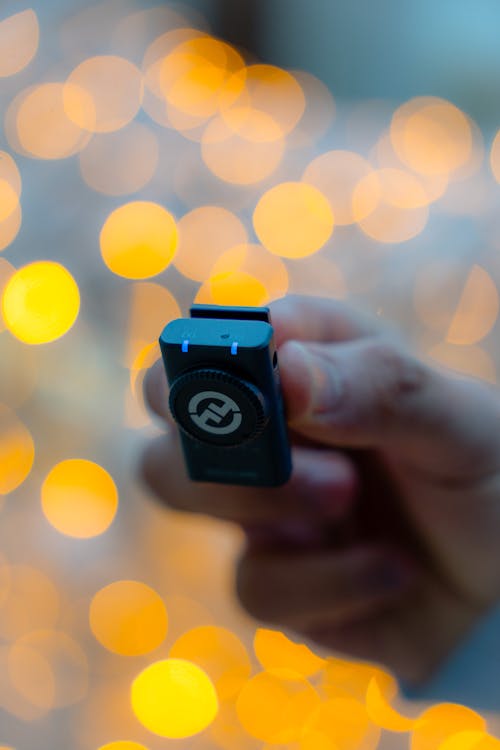 Person Holding a Black Wireless Microphone