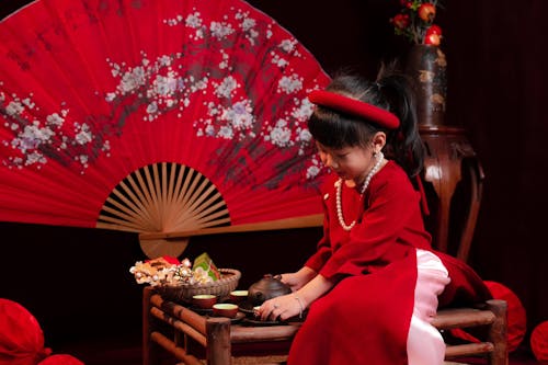 Girl Sitting in Red, Traditional Dress