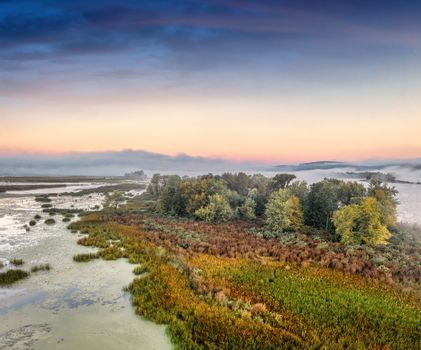 Captivating view of Wabasha wetlands at sunrise with scenic marsh and vibrant foliage.