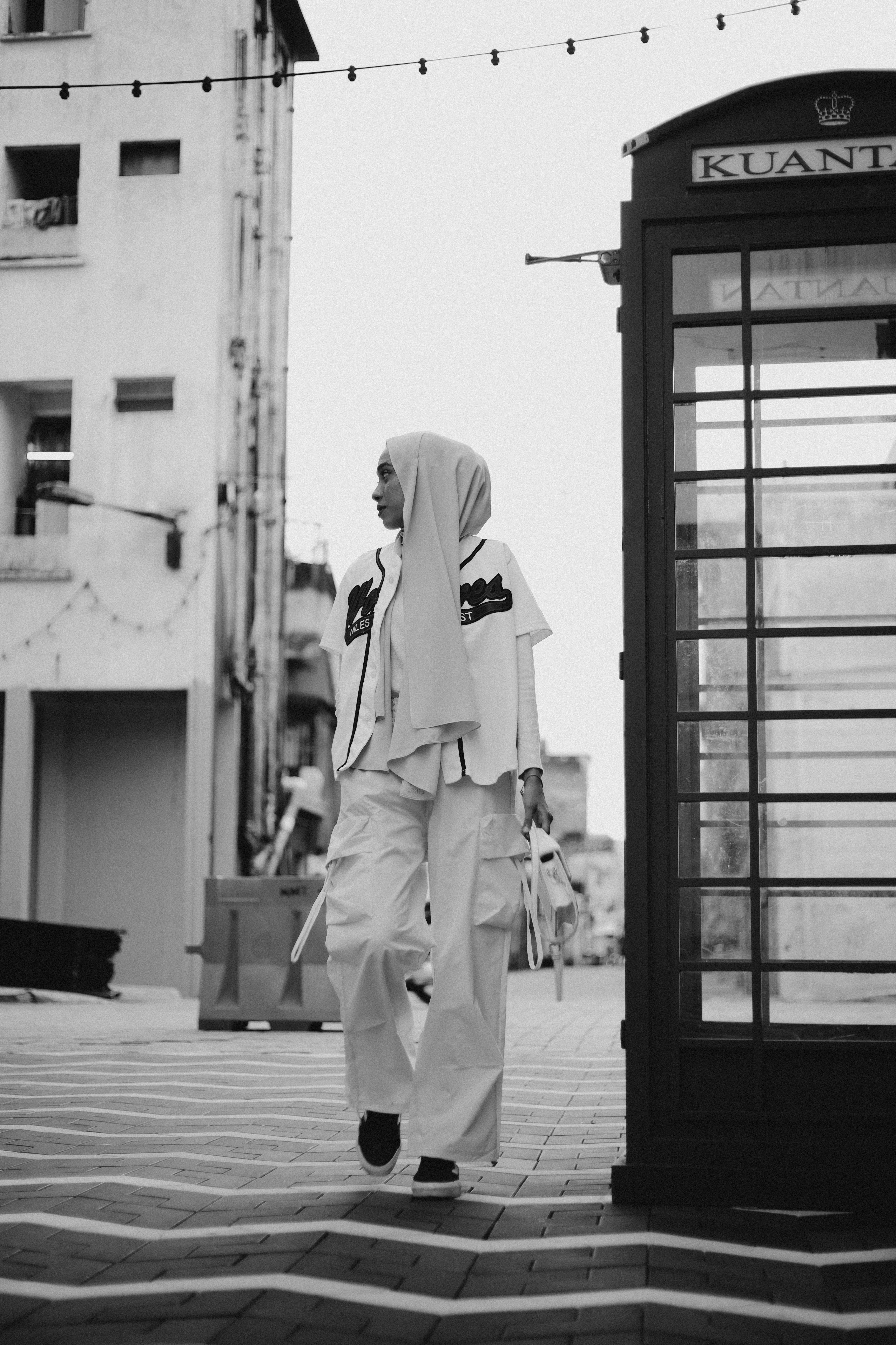 Stylish woman in hijab and cargo pants posing in Kuantan, Malaysia.