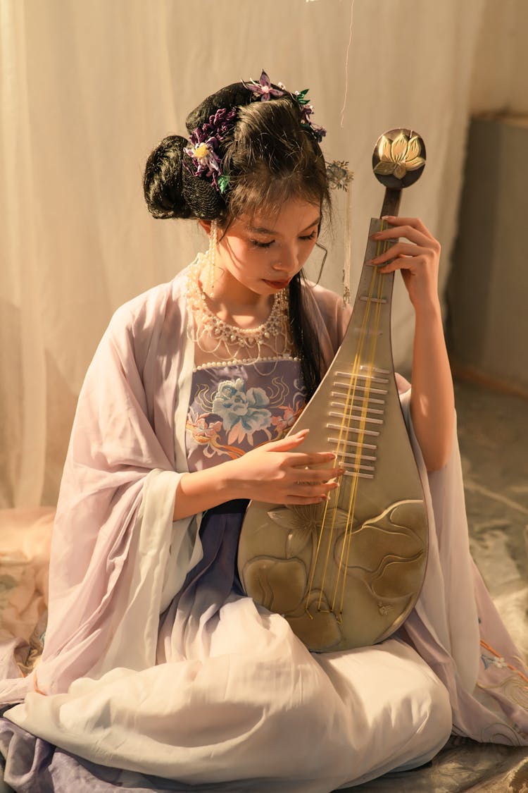 Woman Playing Traditional Instrument Pipa