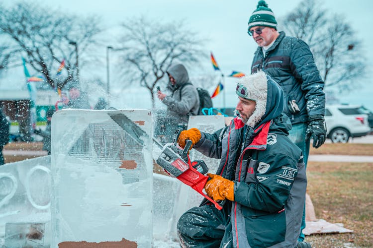 Man Cutting Ice With An Electric Saw