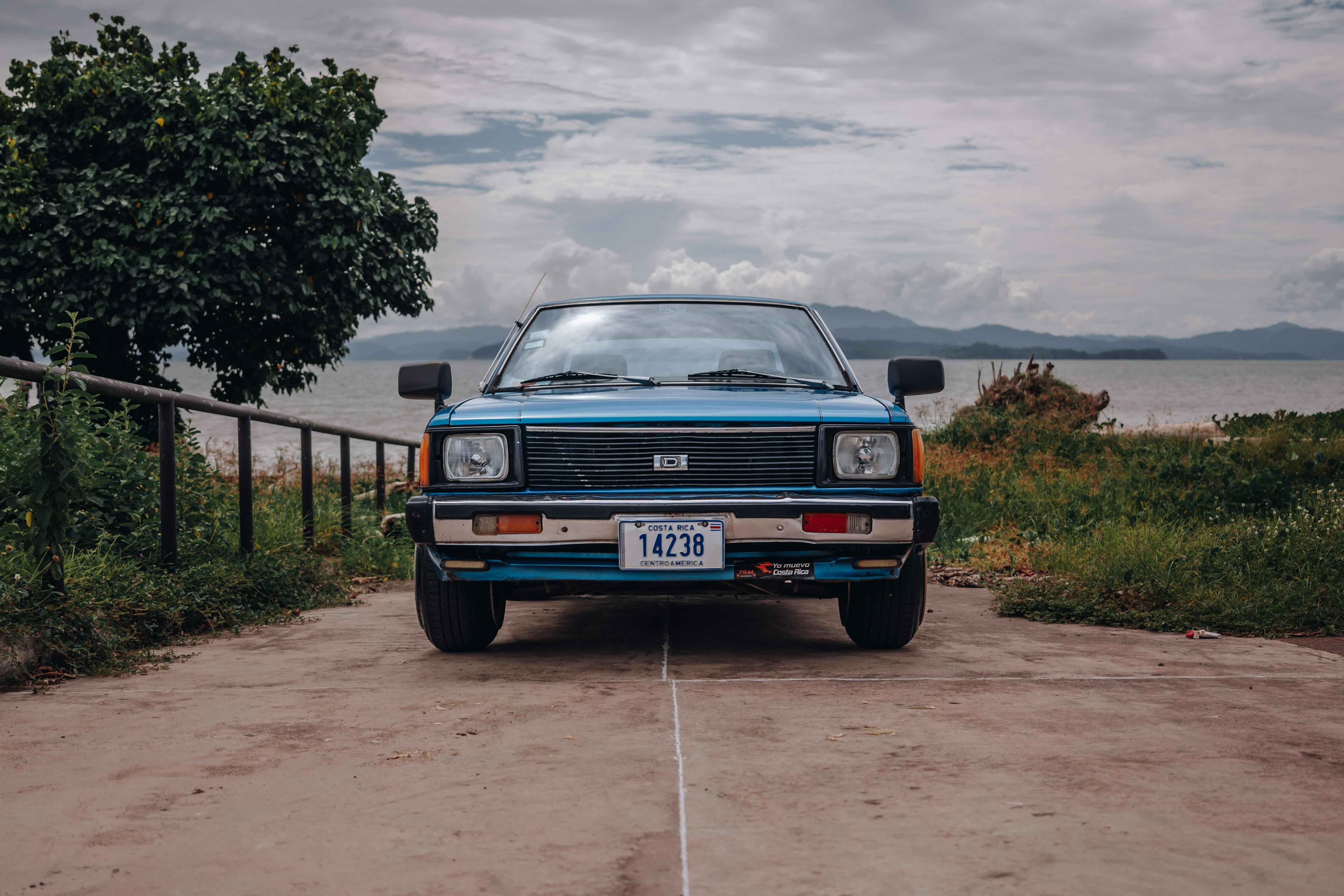 blue classic datsun sunny b310 by the lake