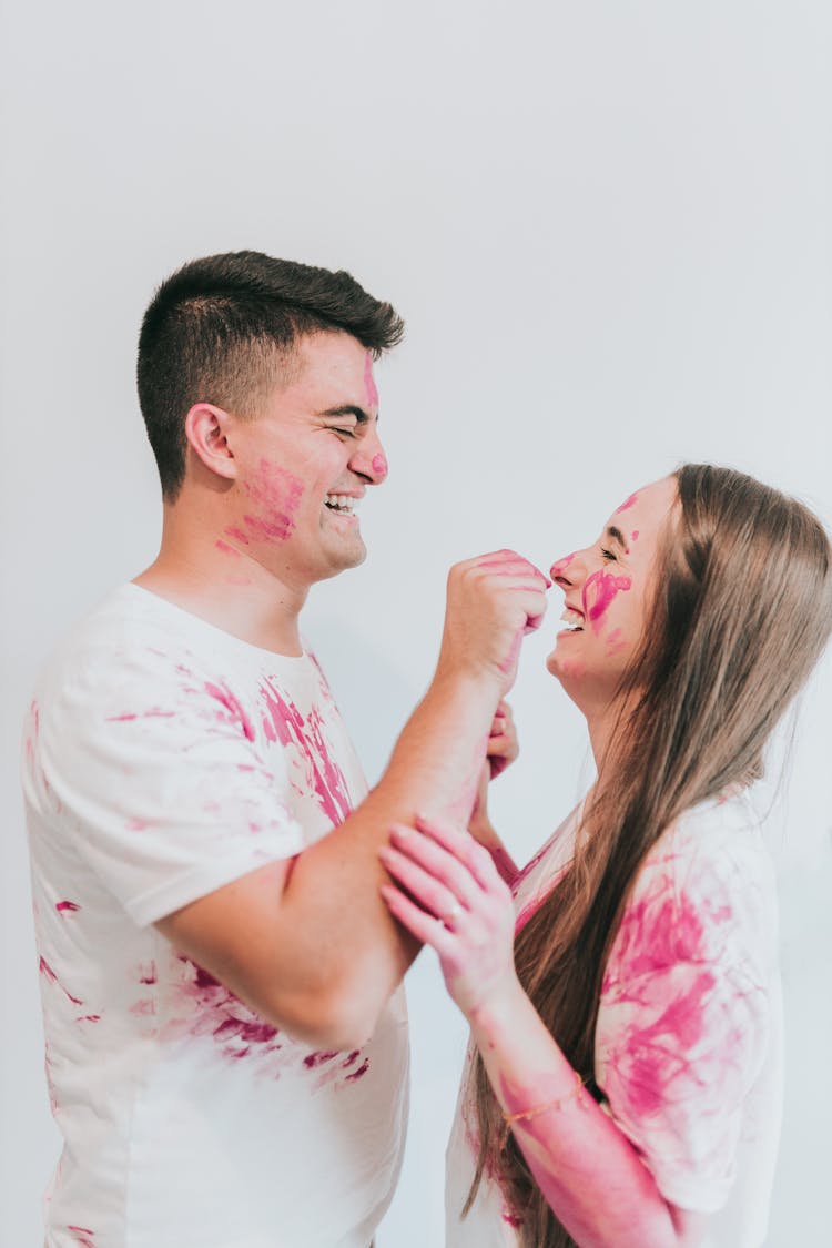 Laughing Couple Playing With Paint