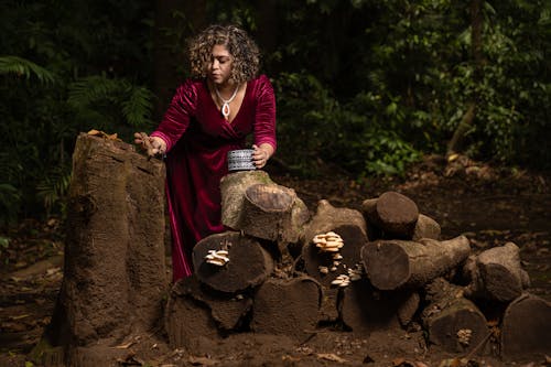 Woman in a Satin Dress Greasing an Old Stump in the Forest