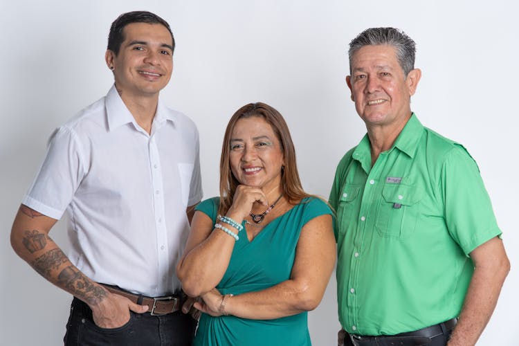 Studio Shot Of Senior Parents With Their Adult Son 