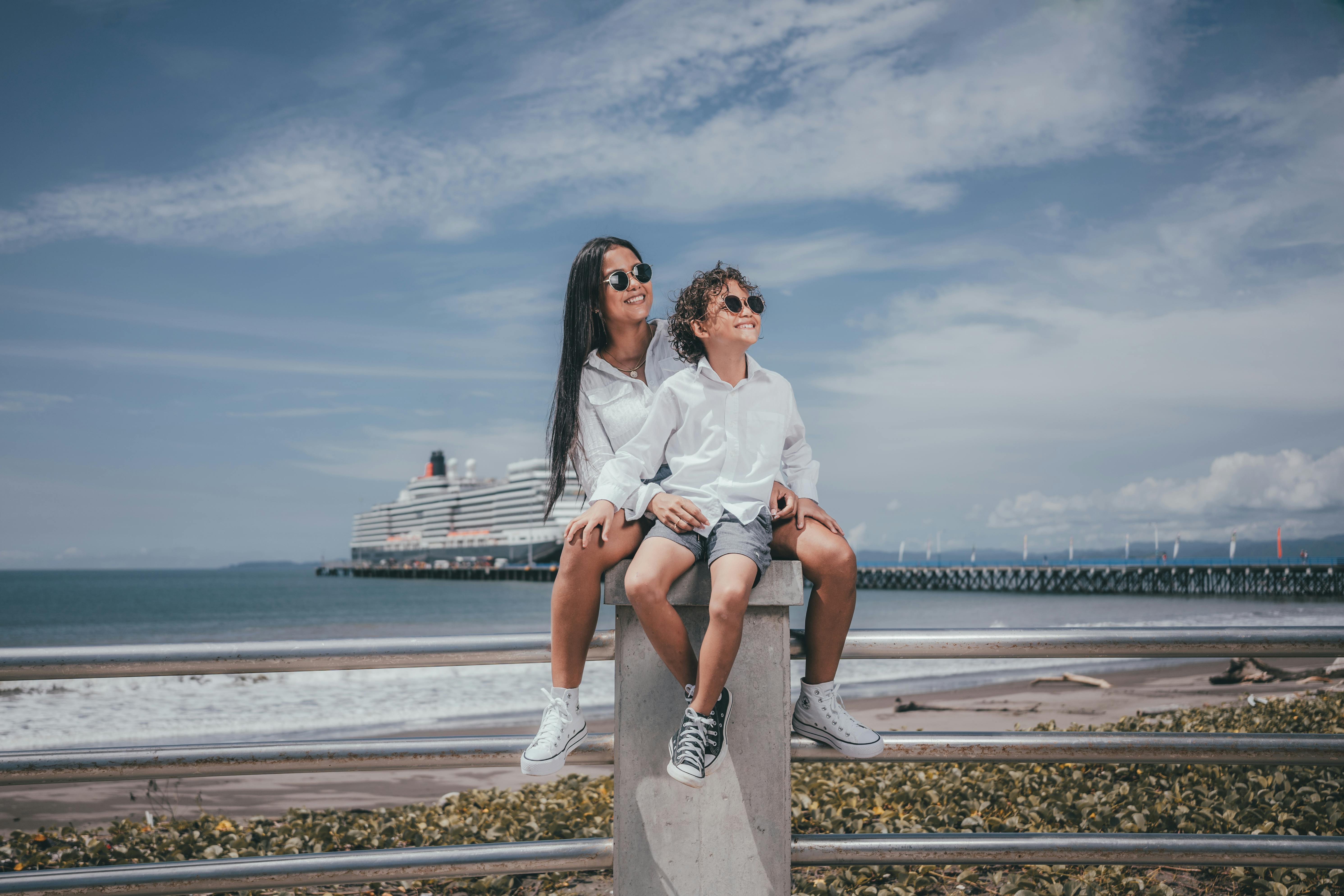 woman sitting on a pier with her son and smiling