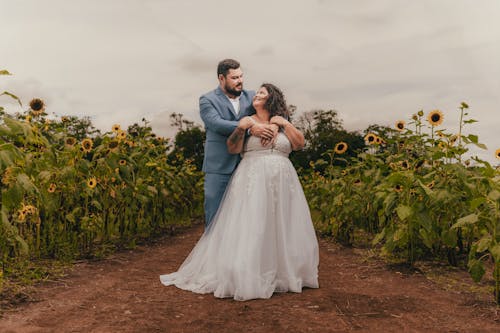 Bride and Groom Posing in a Sunflower Field 
