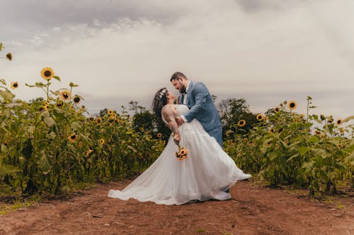 Bride and Groom Posing in a Sunflower Field 