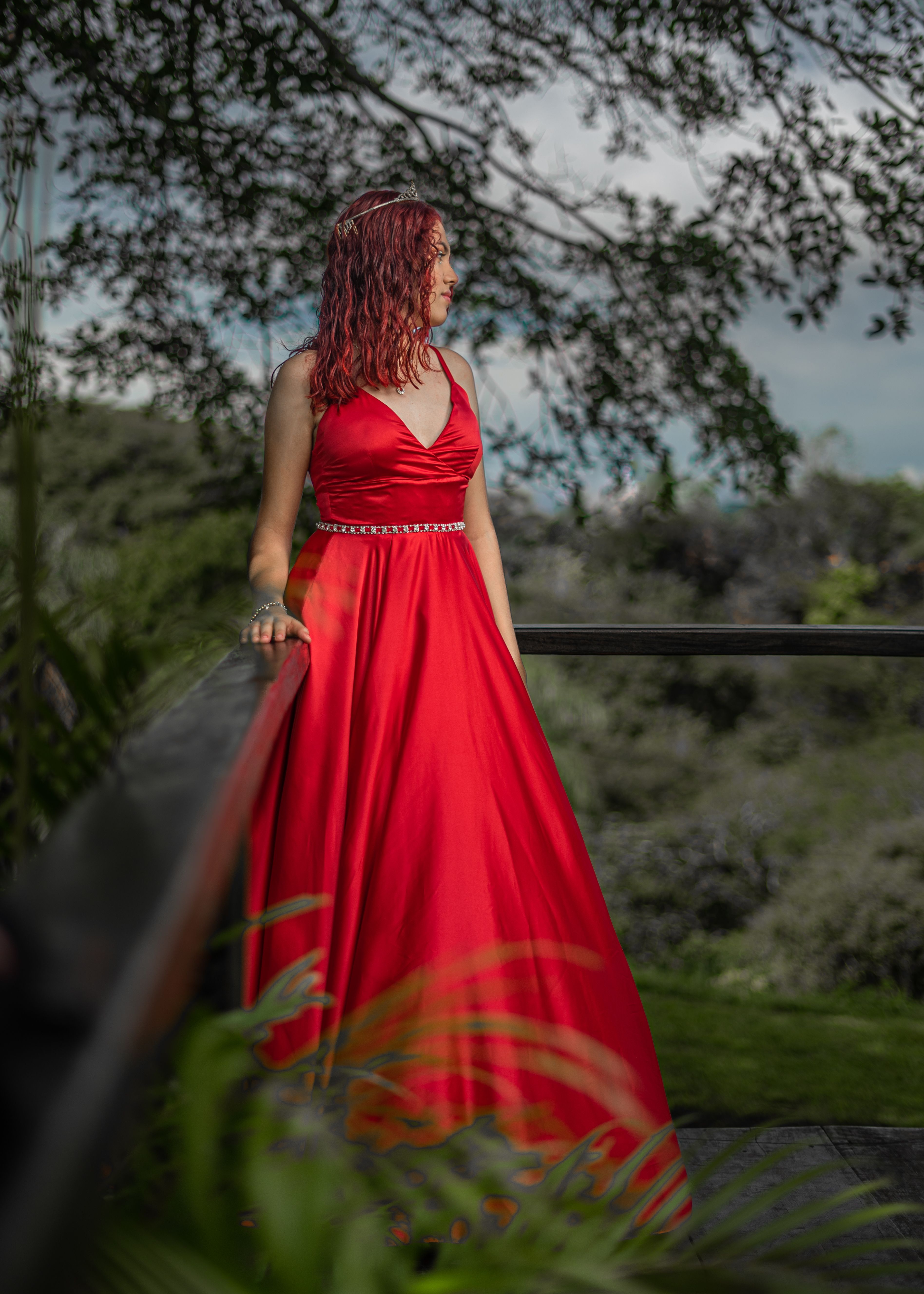 Young Woman in a Red Dress Leaning on a Railing · Free Stock Photo