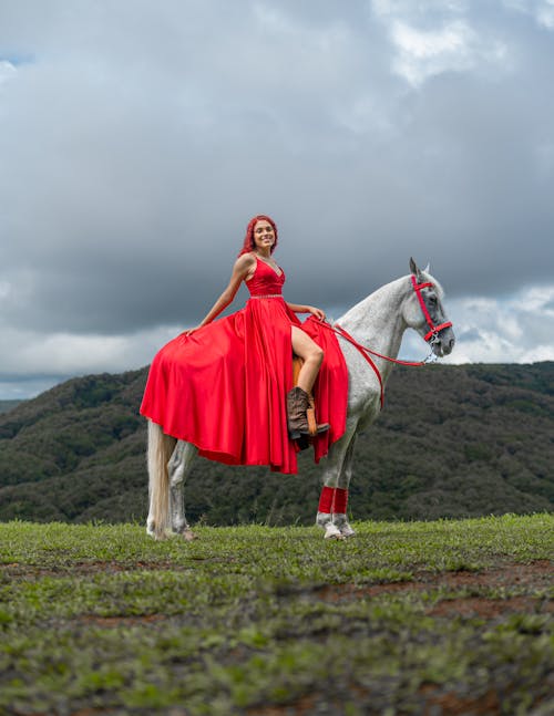 Portrait of a Young Woman Wearing a Red Evening Gown Sitting on a Horse