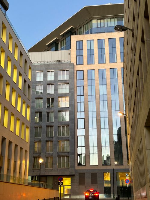 Free A cityscape view of modern office buildings with glass facades and evening lighting. Stock Photo