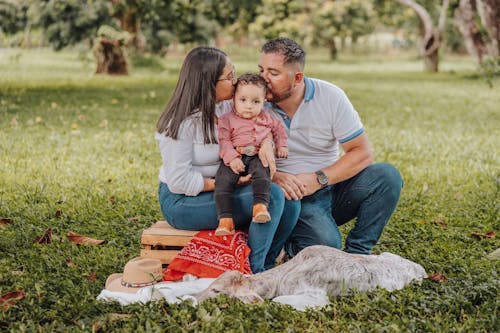 Free Mother and Father Kissing Son Stock Photo