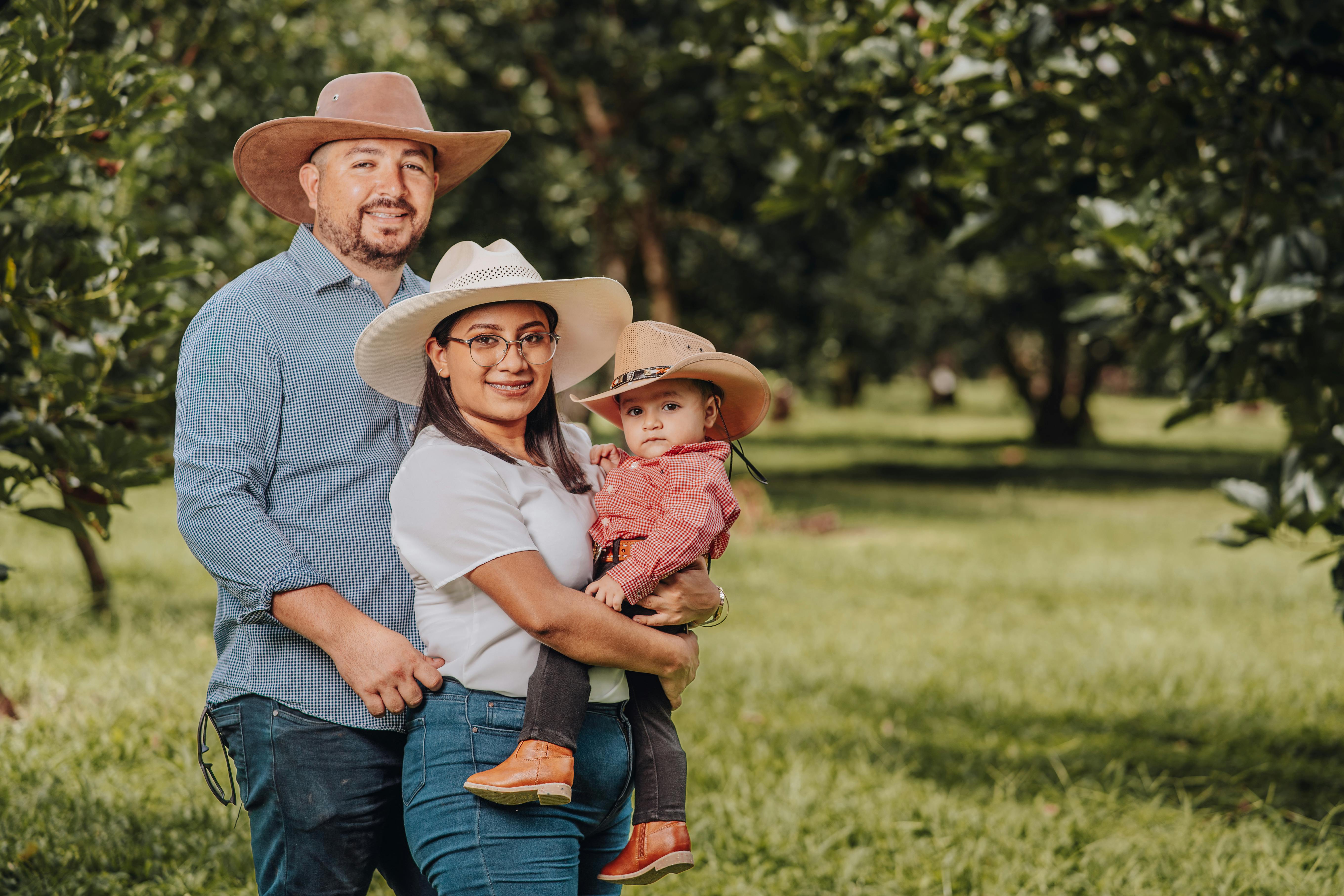 family in cowboy hats smiling