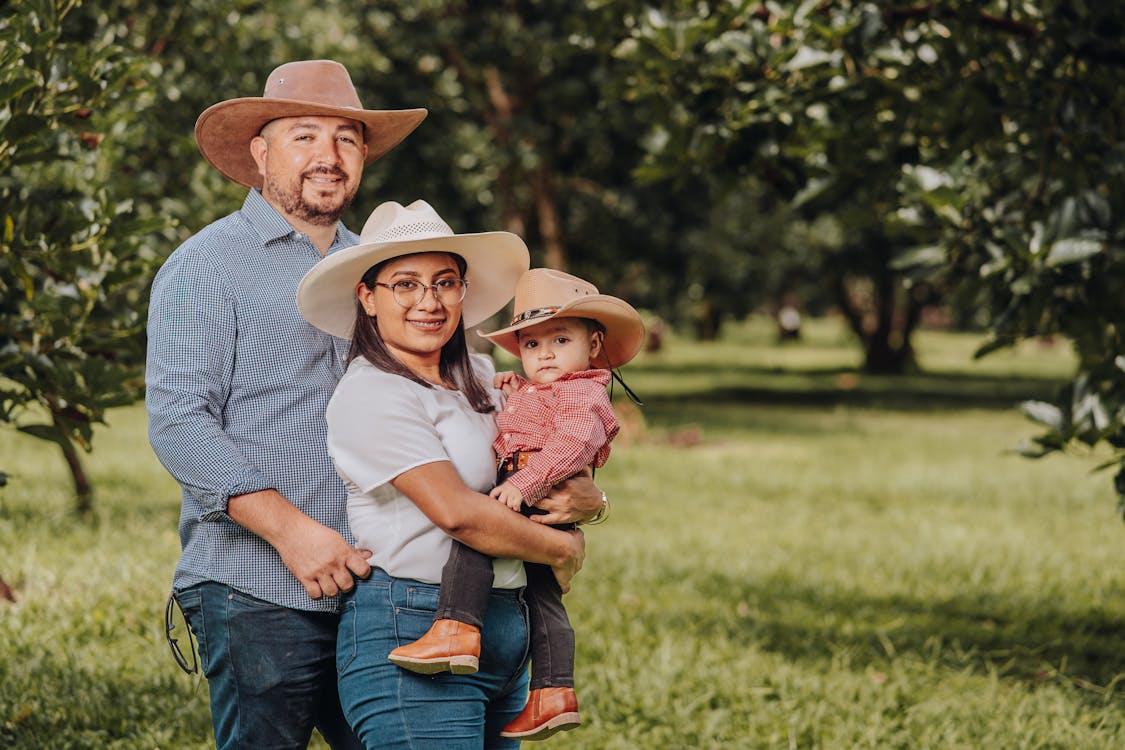 Family in Cowboy Hats Smiling · Free Stock Photo