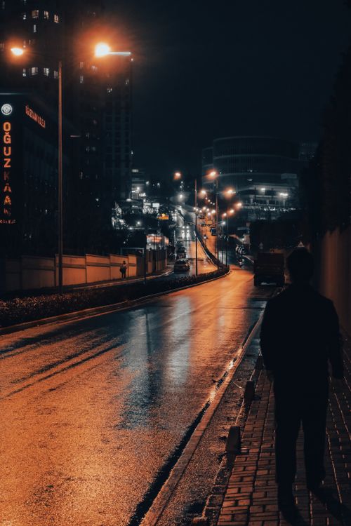 Free Dramatic night view of a deserted city street with glowing street lamps in İstanbul, Türkiye. Stock Photo