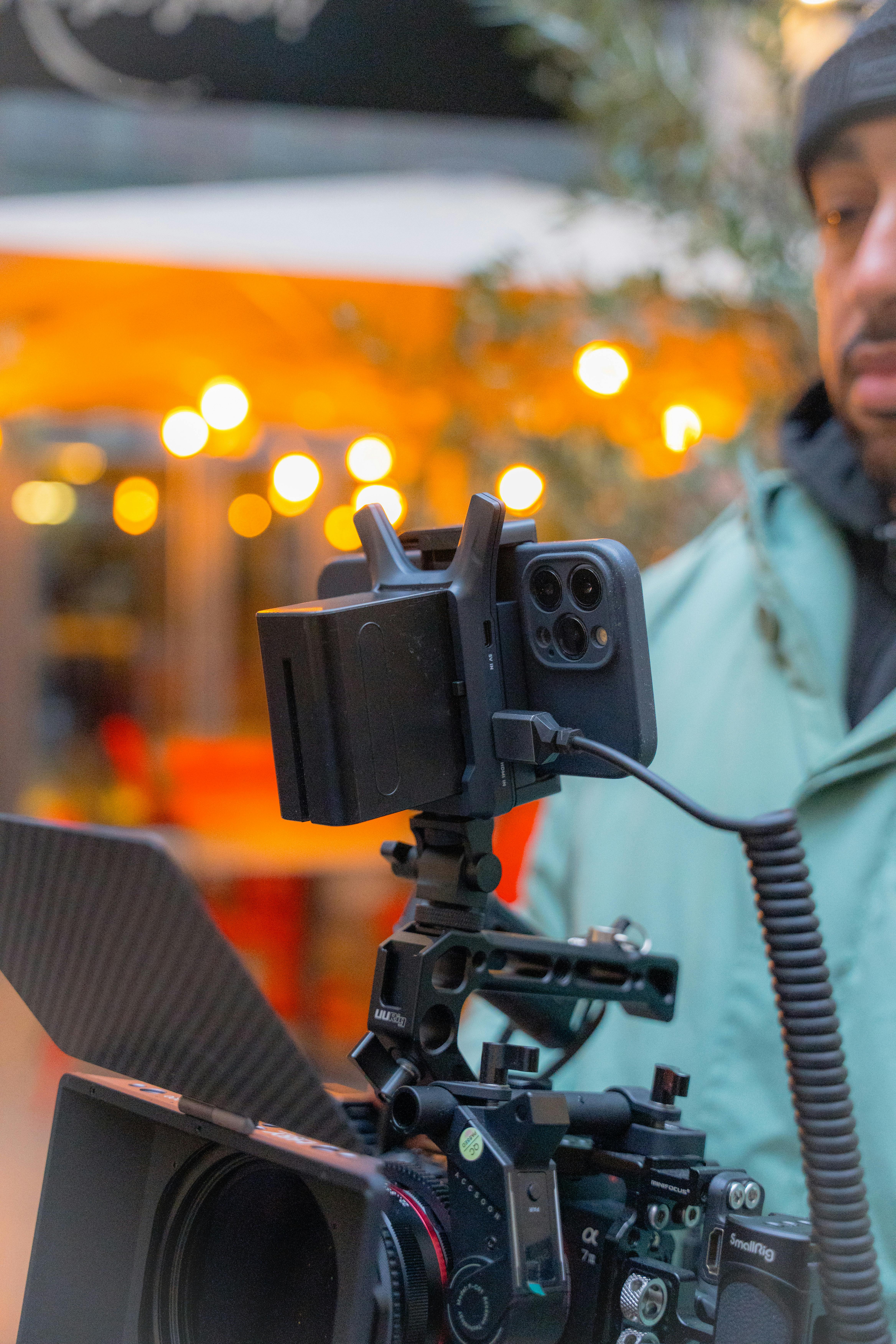 close up of a man holding a professional filming equipment