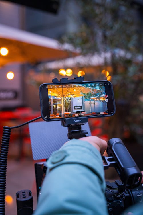 Close-up of a Person Holding a Professional Camera with the Viewfinder Displaying a Picture 