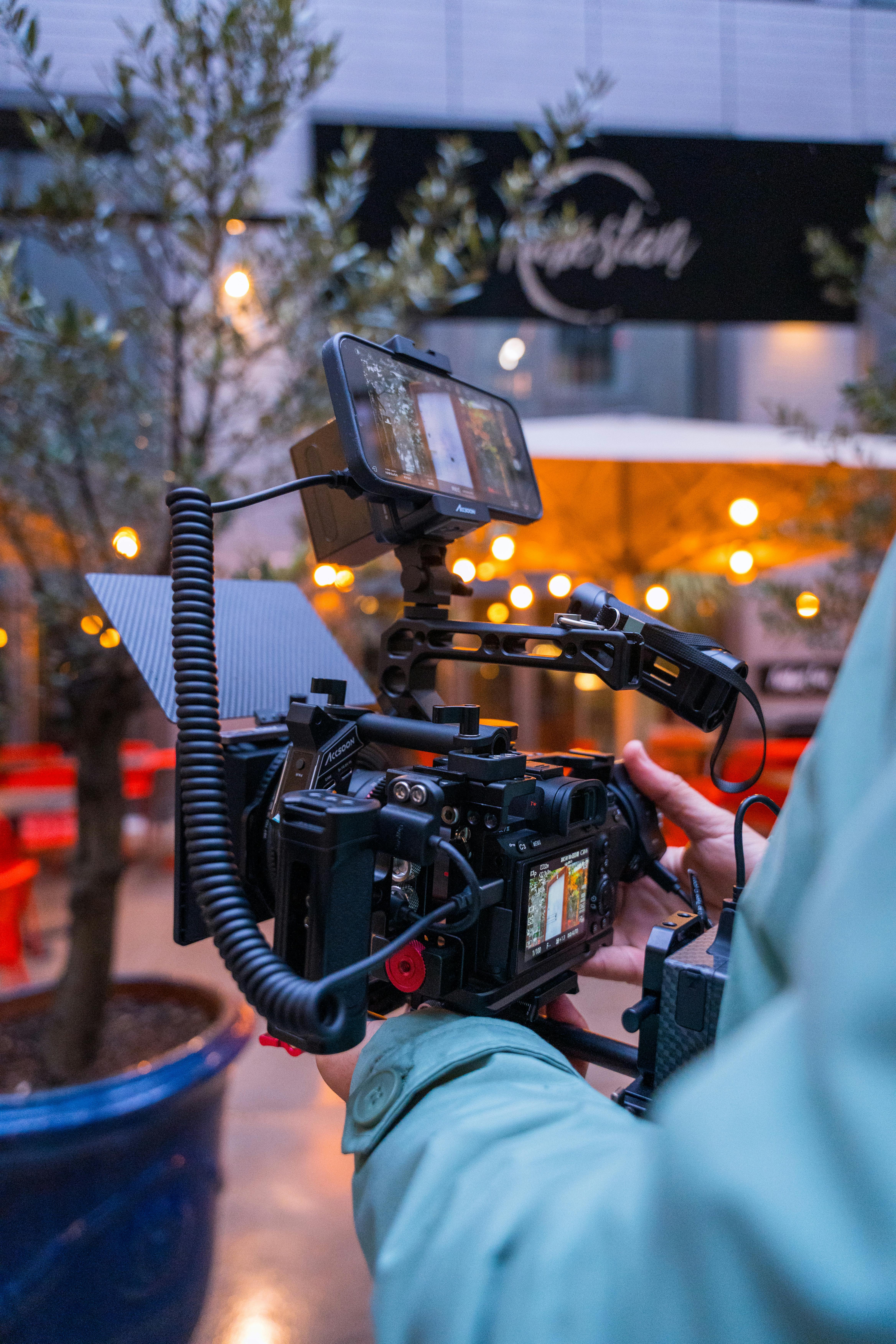 Person Using a Professional Video Camera and Recording · Free Stock Photo