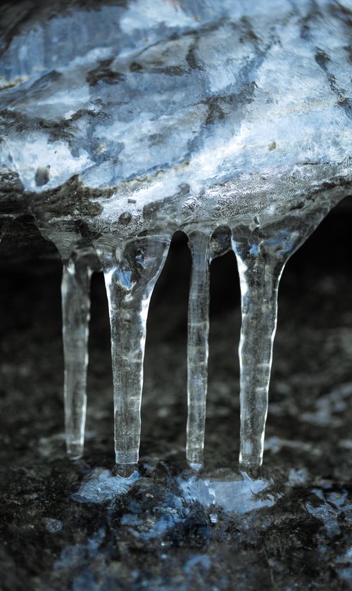 Free Close-up of jagged icicles hanging inside a cold, frozen cave. Stock Photo